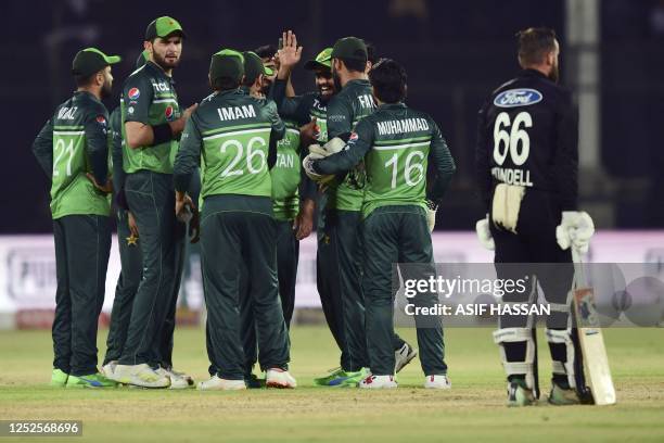 Pakistan's cricketers celebrate after the dismissal of New Zealand's Will Young during the third one-day international cricket match between Pakistan...