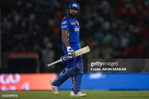 Mumbai Indians' Rohit Sharma walks back to the pavilion after his dismissal during the Indian Premier League Twenty20 cricket match between Punjab...