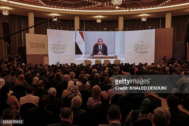 Egypt's President Abdel Fattah al-Sisi addresses the representatives of syndicates, political forces, and NGOs, via video conference during the...