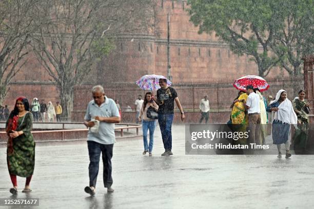 Visitors out on rain at Red Fort, on May 3, 2023 in New Delhi, India.