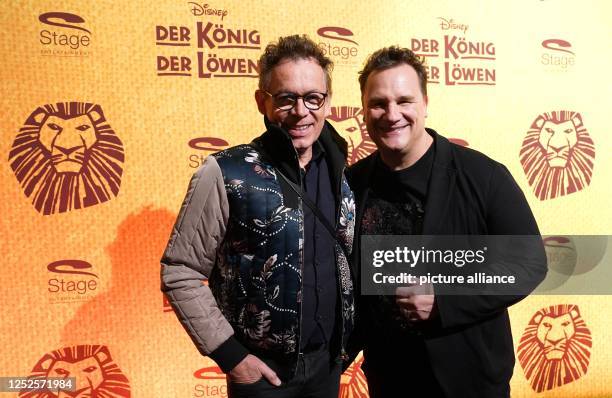 Guido Maria Kretschmer , fashion designer, and Frank Mutters, painter, walk the red carpet for the anniversary gala of "The Lion King" at the Stage...