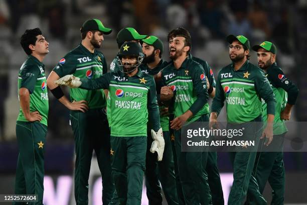 Pakistan's cricketers celebrate after the dismissal of New Zealand's Henry Nicholls during the third one-day international cricket match between...