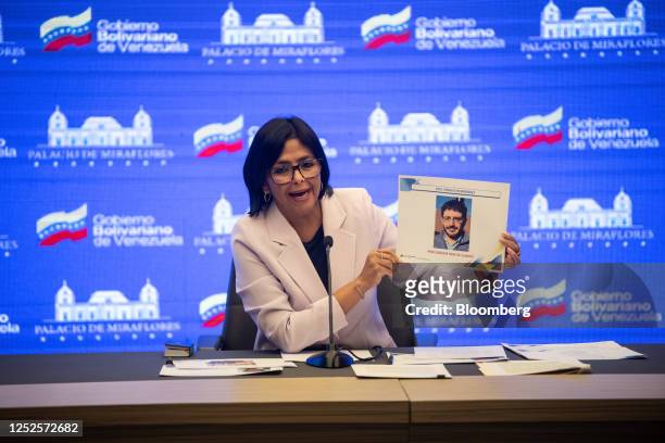 Delcy Rodriguez, Venezuela's vice president, holding a picture of members of the opposition during a news conference at Miraflores Palace in Caracas,...