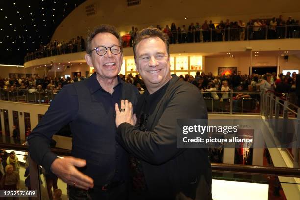 Frank Mutters , painter, and Guido Maria Kretschmer, fashion designer, stand during a break in the anniversary gala "The Lion King" at the Stage...