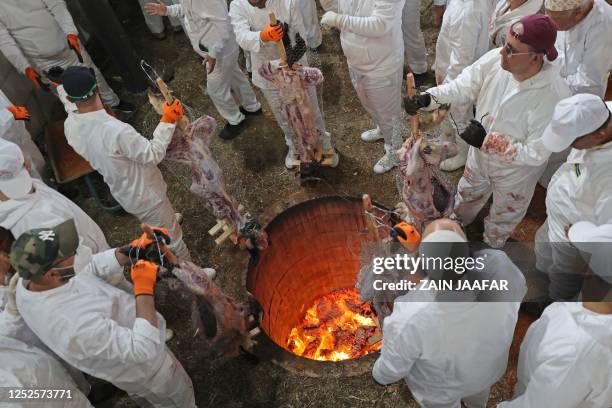 Samaritans take part in the traditional Passover sacrifice at Mount Gerizim near the northern West Bank city of Nablus on May 3, 2023. Only around...