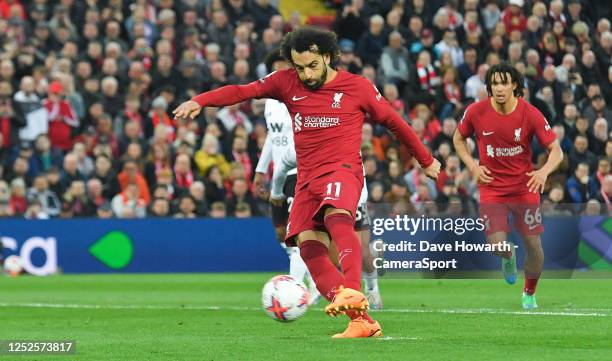 Liverpool's Mohamed Salah scores his team's first goal during the Premier League match between Liverpool FC and Fulham FC at Anfield on May 3, 2023...