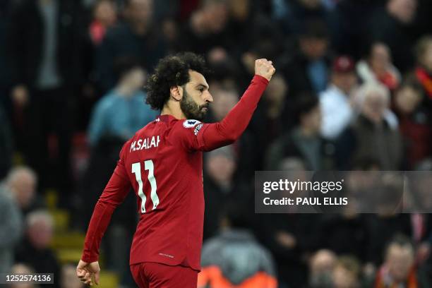 Liverpool's Egyptian striker Mohamed Salah celebrates after shooting a penalty kick and scoring his team first goal during the English Premier League...