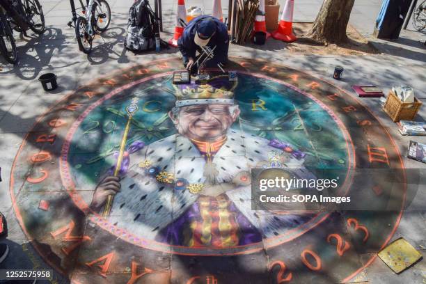 Chalk artist Julian Beever draws a tribute to King Charles III on a pavement near Trafalgar Square ahead of the coronation.