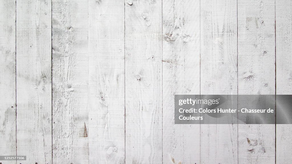 White wooden plank wall painted with natural patina