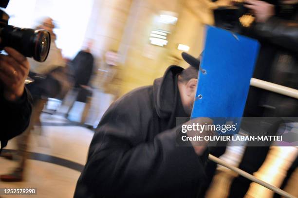 One of the accused arrives at the Paris courthouse, on February 4 to attend the first day of the trial involving a multi-million dollar scam between...