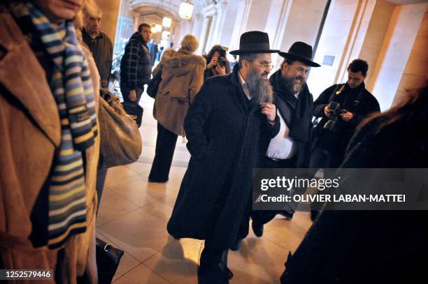 People arrive at the Paris courthouse, on February 4 to attend the first day of the trial involving a multi-million dollar scam between France and...