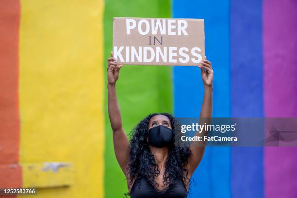 young african american woman holding protest sign - violence prevention stock pictures, royalty-free photos & images