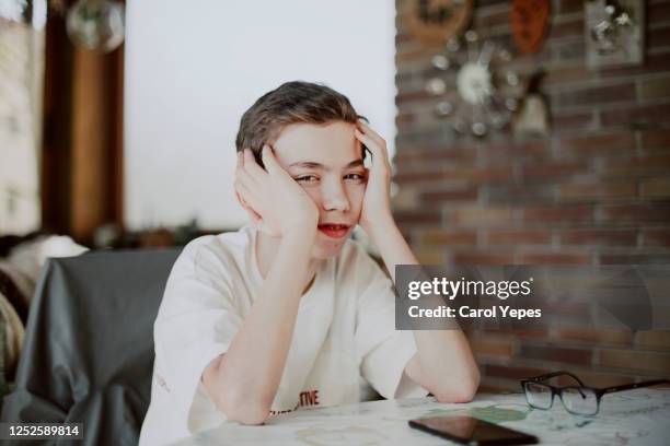 portrait of sad bored teenager boy just looking to camera - spain teen face imagens e fotografias de stock