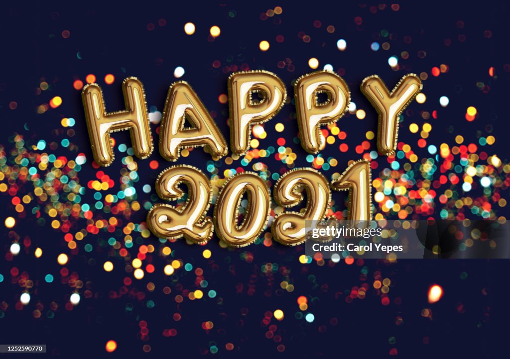 Happy new year 2021 foiled golden balloon in black background with confetti