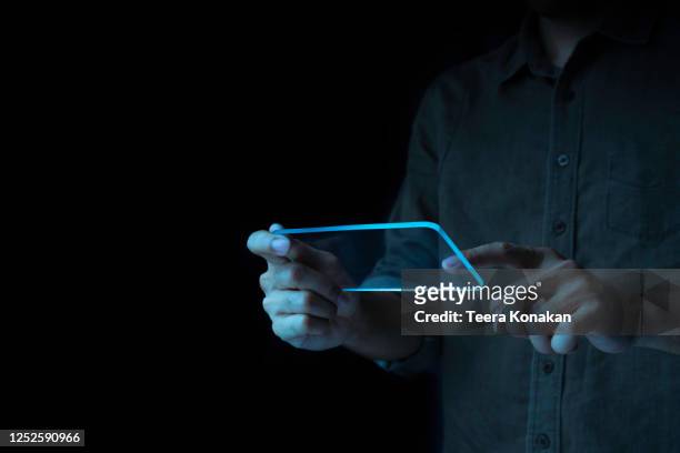 businessmen are using tablet computers to analyze trends of fast-growing businesses with rising graph bars on a black background. - future of media stock-fotos und bilder
