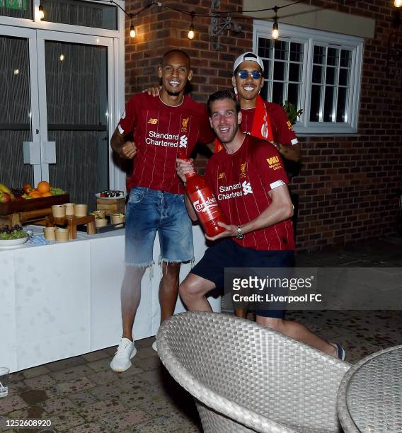 Fabinho, Roberto Firmino and Adrian of Liverpool celebrating winning the Premier League on June 25, 2020 in Liverpool, England.
