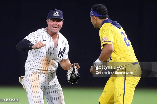 New York Yankees alumni Nick Swisher dances in right field with Savannah Bananas Dakota McFadden during the game between the Savannah Bananas and the...