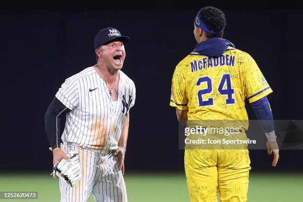 New York Yankees alumni Nick Swisher dances in right field with Savannah Bananas Dakota McFadden during the game between the Savannah Bananas and the...