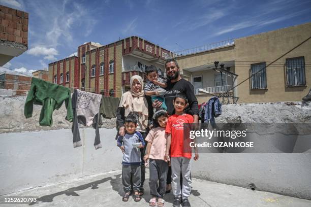 Syrian refugee Neroz Hussein , her husband Adil Sheho and their children pose at her house in the southwest of the city centre of Sanliurfa on April...