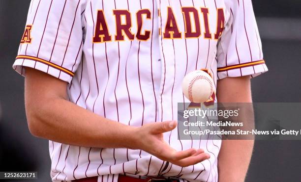 Starting pitcher Ian Hoffstetter of Arcadia flips the baseball before being pulled out of the game in the sixth inning of a Division 1 first round...