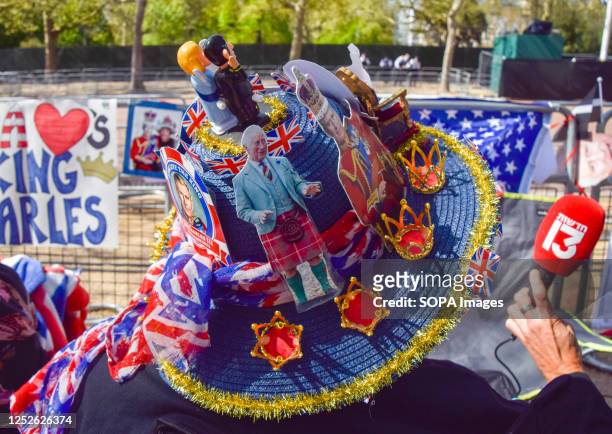 Royal superfan wears an elaborate hat in her camp on The Mall near Buckingham palace ahead of the coronation of King Charles III, which takes place...