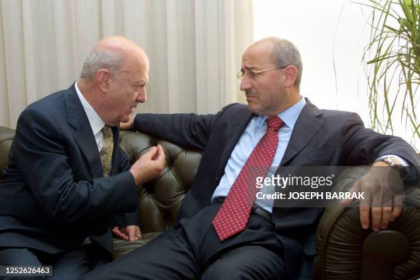 Lebanese Information Minister Ghazi Aridi listens to Christian opposition MP Gabriel Murr, the owner of MTV during a meeting at the Lebanese Press...