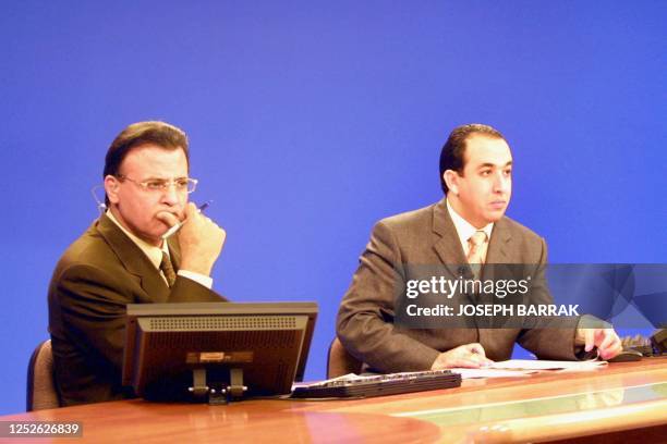Al-Jazeera's news speakers Abdel Samad Nasser and Jamal Rayan are seen at the studios of the Qatari satellite network's headquarters in Doha 10...