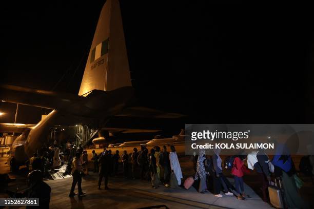 Fleeing Nigerian citizens evacuated from Sudan, disembark from the Nigerian Airforce aircraft at the Nnamdi Azikwe International Airport in Abuja,...