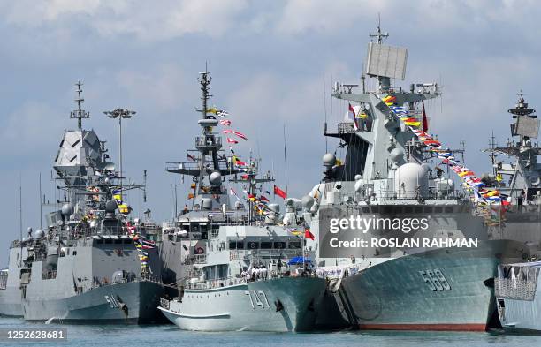 Chinese Navy missile frigate Yulin and the minesweeper hunter Chibi are seen docked at Changi Naval Base during the IMDEX Asia warships display in...