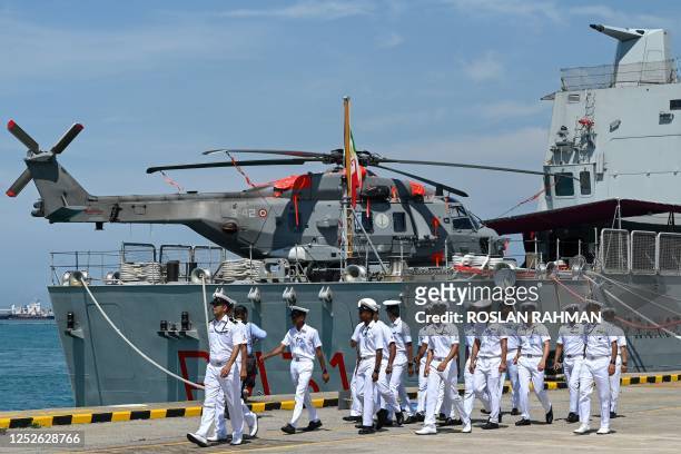 Indian navy members walk past the Italian offshore patrol vessel Francesco Morosini docked at Changi Naval Base during the IMDEX Asia warships...