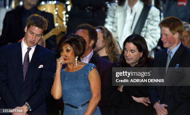 Prince William talks with Dame Shirley Bassey as Ozzy Osbourne stands with Prince Harry on stage at the finale of "Party at the Palace" in London 03...