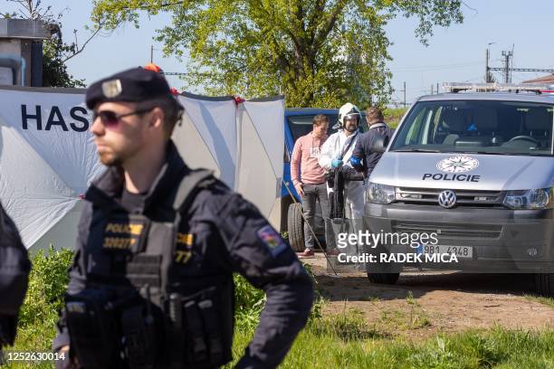 Police investigators work at the scene of a fire which left eight people dead in Brno, Czech Republic, on May 4 2023. - "The fire spread in a module...