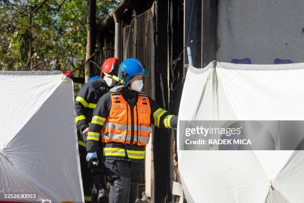 Police investigators work at the scene of a fire which left eight people dead in Brno, Czech Republic, on May 4 2023. - "The fire spread in a module...