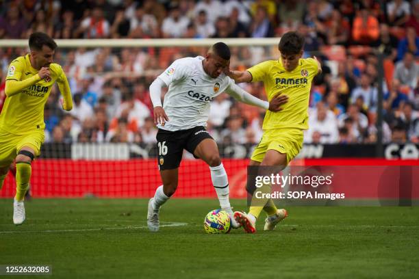 Samuel Lino of Valencia CF and Juan Marcos Foyth of Villarreal CF in action during the LaLiga Santander Regular Season Round 33 between Valencia and...
