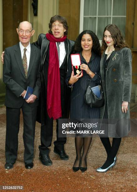 Lead singer of British group the Rolling Stone Sir Mick Jagger stands with his 92-year-old father, Joe and daughters Karis and Elizabeth after...