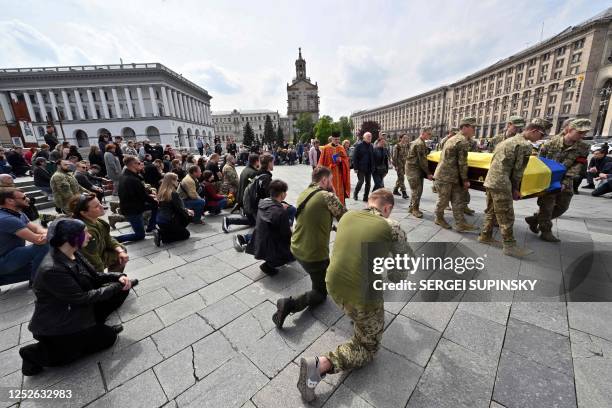 Ukrainian servicemen carry a coffin with the body of Yevgen Kvaskov, a soldier killed on the Bakhmut front, Donetsk region, during the funeral...