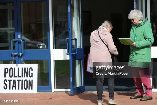 Green Party teller takes a voter's number outside the polling station as voting opens in the local election on May 4, 2023 in Norwich, United Kingdom.