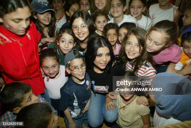 Lebanese singer Haifa Wehbe reads 13 April 2005 stories for children at the Children's Science Museum in downtown Beirut amid national unity...