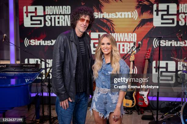 Howard Stern and Carrie Underwood pose at The Howard Stern Show at the SiriusXM Miami studios on May 03, 2023 in Miami Beach, Florida.