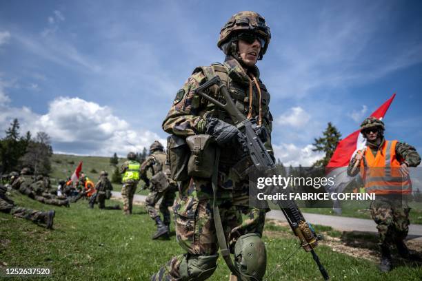 Swiss soldier takes position during a live shooting exercise in the military training area of Les Pradieres next to Les Geneveys-sur-Coffrane during...