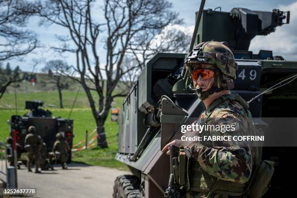 Swiss soldier takes position during a live shooting exercise in the military training area of Les Pradieres next to Les Geneveys-sur-Coffrane during...