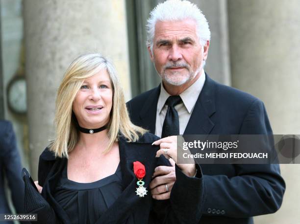 Singer Barbra Streisand poses with her husband James Brolin as she leaves the Elysee Palace after being awarded by French President Nicolas Sarkozy...