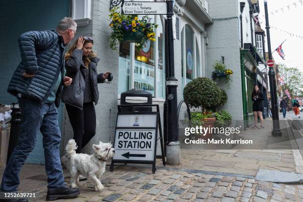 Voters leave a polling station with a dog on 4 May 2023 in Eton, United Kingdom. Today's is the biggest round of local elections since 2019 and the...