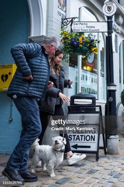 Voters leave a polling station with a dog on 4 May 2023 in Eton, United Kingdom. Today's is the biggest round of local elections since 2019 and the...