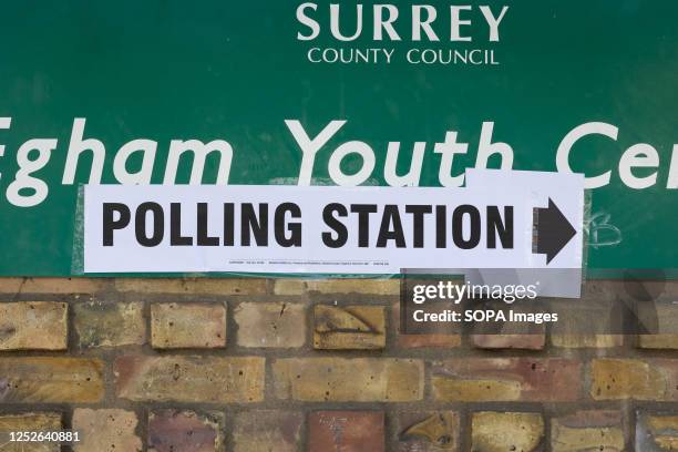 Sign points to a polling station in Egham, as members of the public go to cast their votes. Elections are being held in 230 of England's 317 councils...