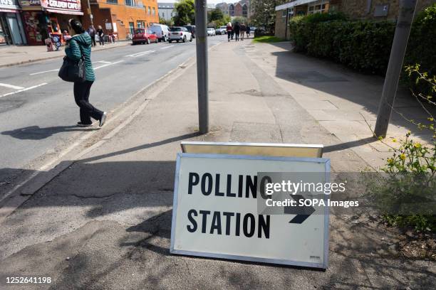 Sign points to a polling station in Egham, as members of the public go to cast their votes. Elections are being held in 230 of England's 317 councils...