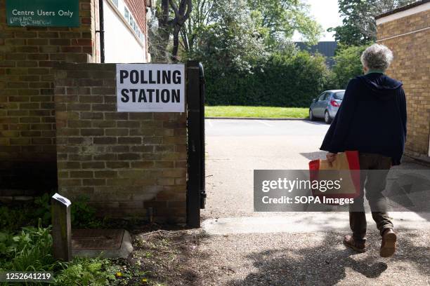 Man walks towards a polling station in Egham, as members of the public go to cast their votes. Elections are being held in 230 of England's 317...