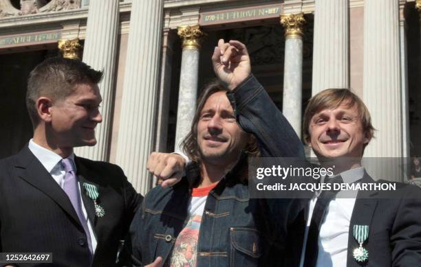 French DJ star Bob Sinclar poses flanked by Antoine Baduel , head of the FG Dj radio and French musician Martin Solveig both decorated by the order...