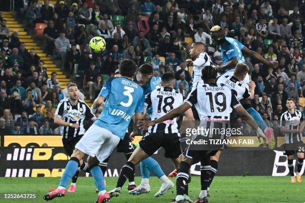 Napoli's Nigerian forward Victor Osimhen and Udinese's Brazilian defender Rodrigo Becao go for a header during the Italian Serie A football match...