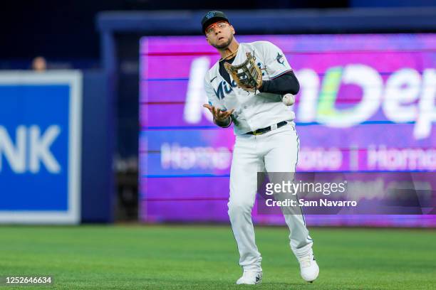 Yuli Gurriel of the Miami Marlins reacts after dropping the baseball against the Atlanta Braves during the first inning at loanDepot park on May 04,...